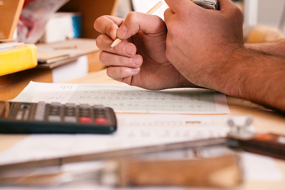 Artisan du bâtiment calculant réalisant un budget